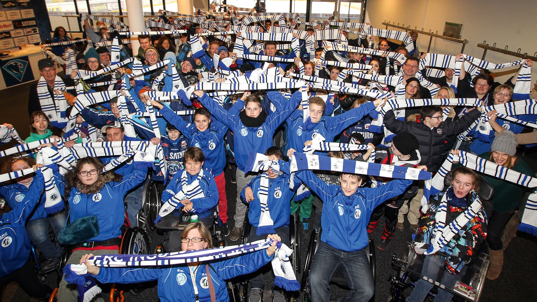 Kinder, die ihre Fußball-Schale in die Luft halten